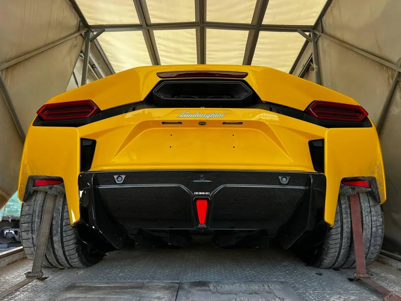 Yellow Lamborghini Temerario secured inside an enclosed car transporter