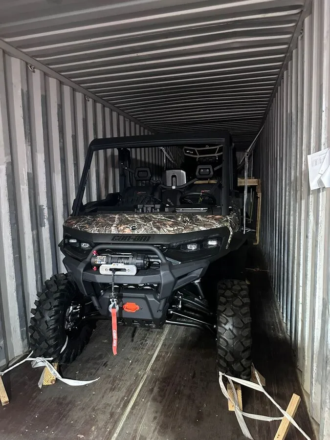 Can-Am Defender side-by-side secured inside the container.