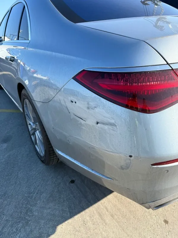 Rear quarter of a Mercedes showing bumper scuffs in an owner-confirmed insurance claim