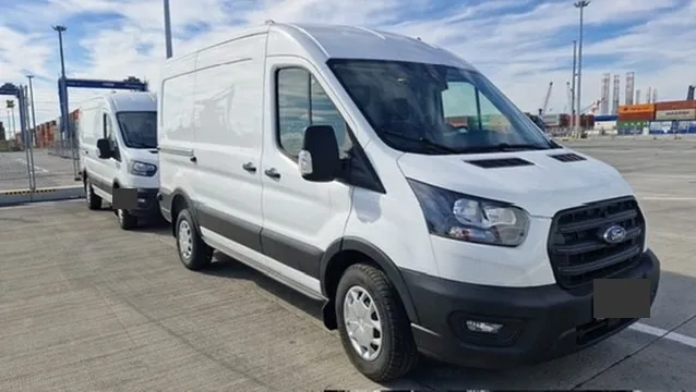 Commercial vans from the series at a vehicle yard.