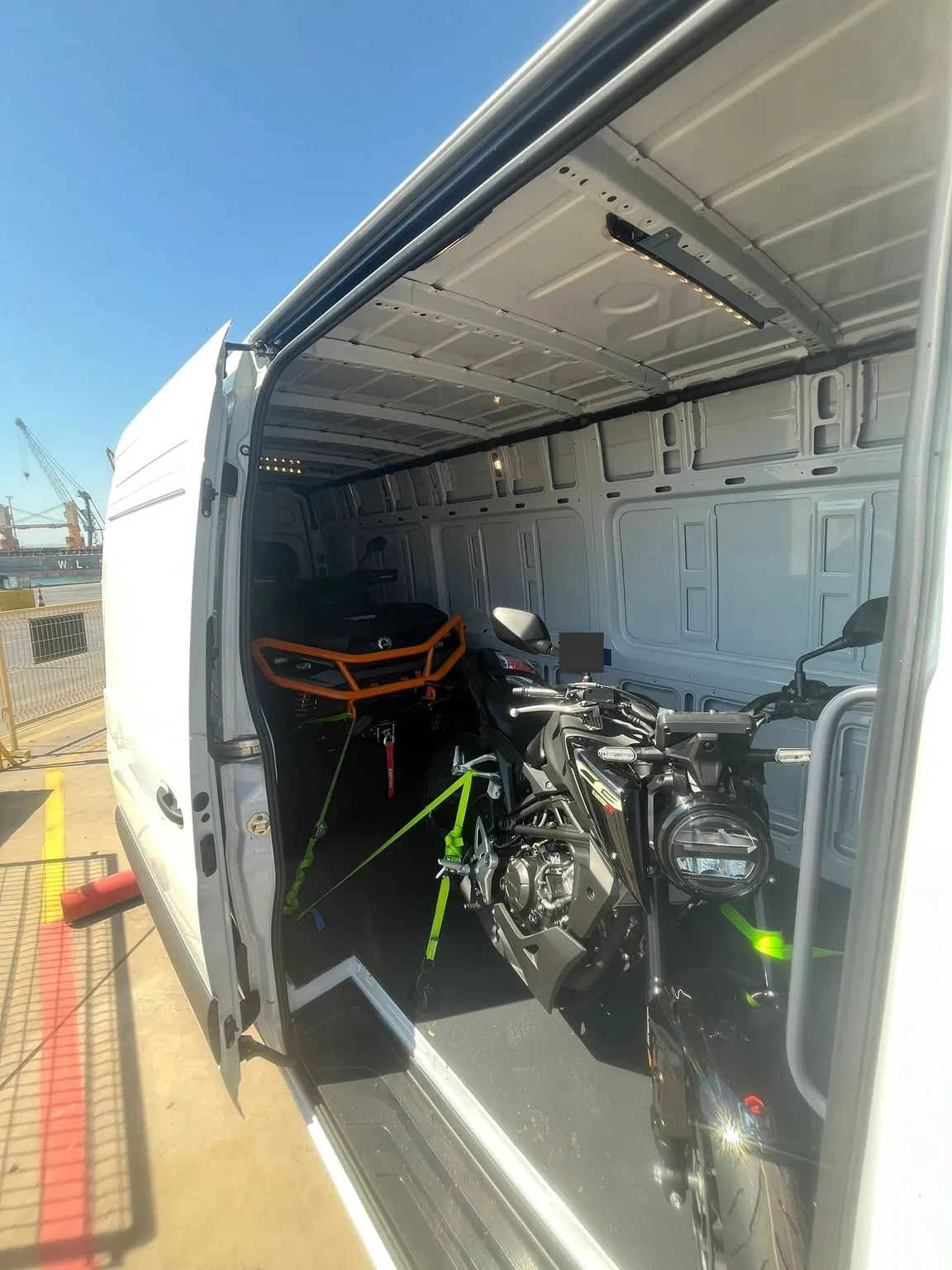 Motorcycles and an ATV inside a larger van. The series included different types of equipment.