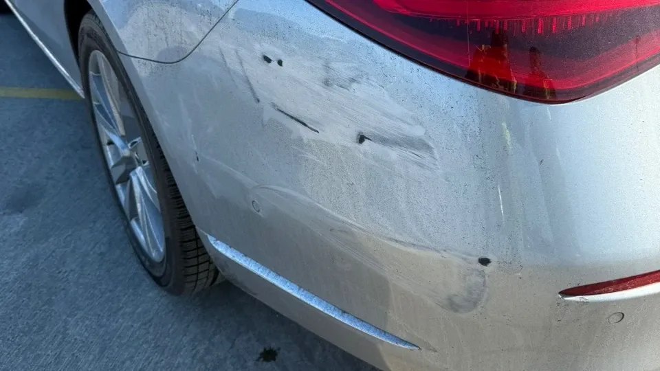 Detail of Mercedes rear bumper damage from an owner-confirmed insurer-paid claim
