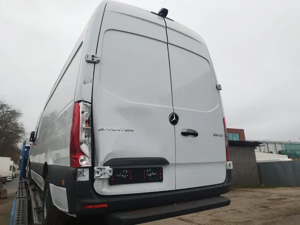 Rear of the Sprinter showing damage to the left door and lamp