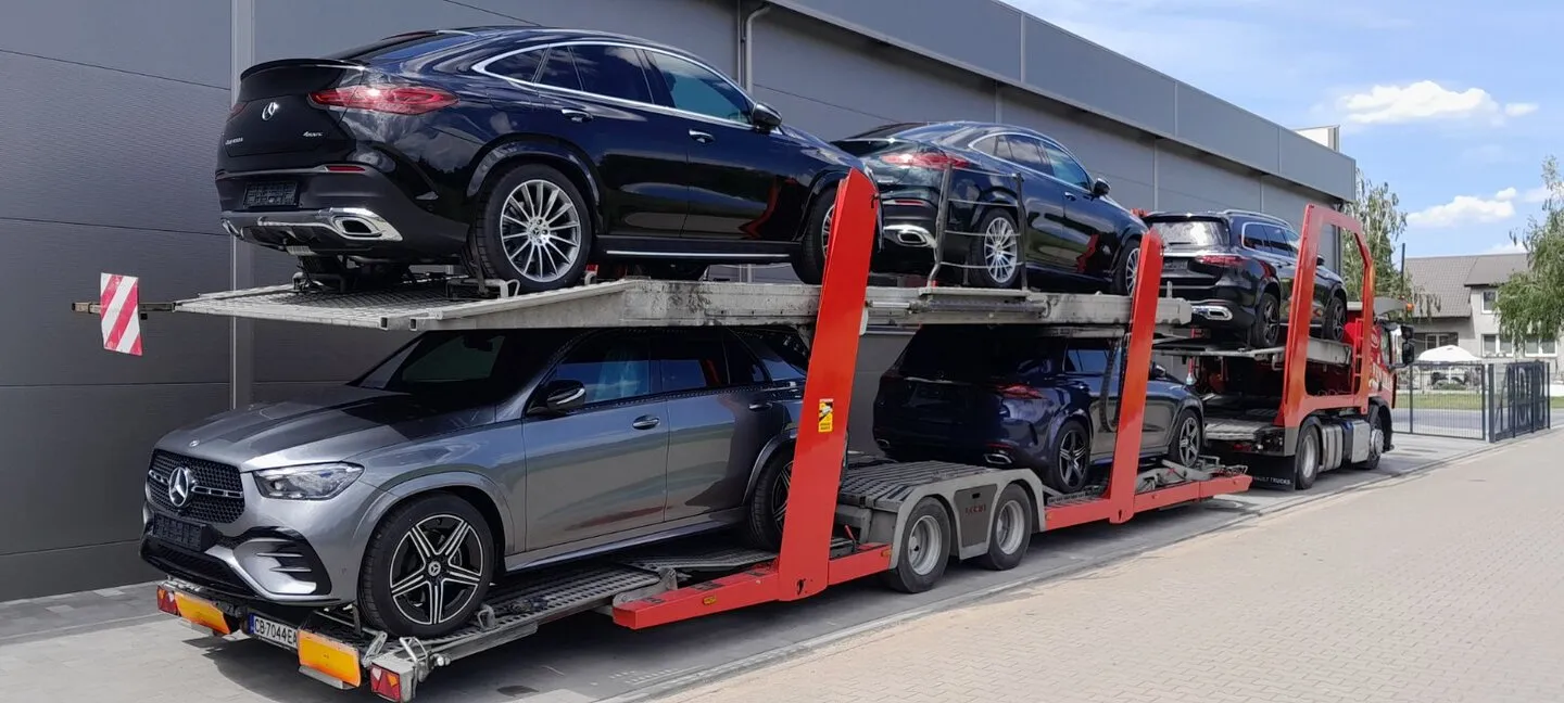 A batch of Mercedes-Benz vehicles on an open car transporter